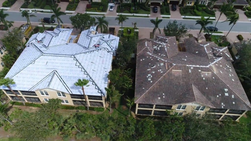 Roofs being repaired after experiencing wind damage in Naples, Florida