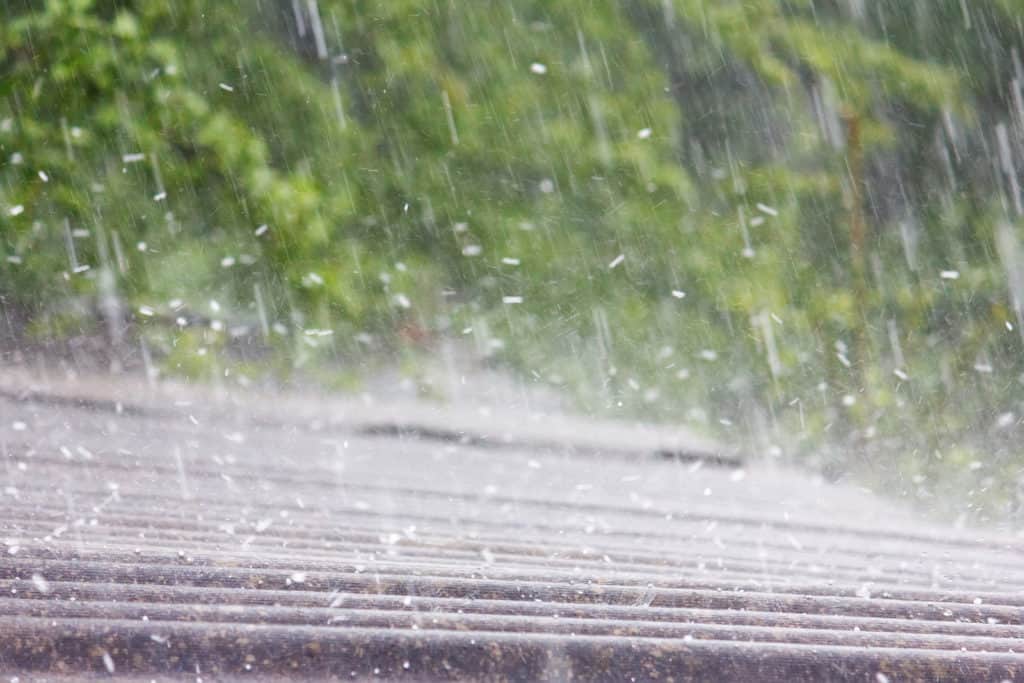 Hail creating storm damage on a residential roof